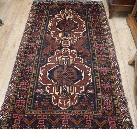 A Caucasian dark red ground rug 205 x 115cm